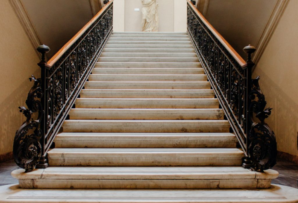 vertical-low-angle-shot-staircase-inside-beautiful-historic-building